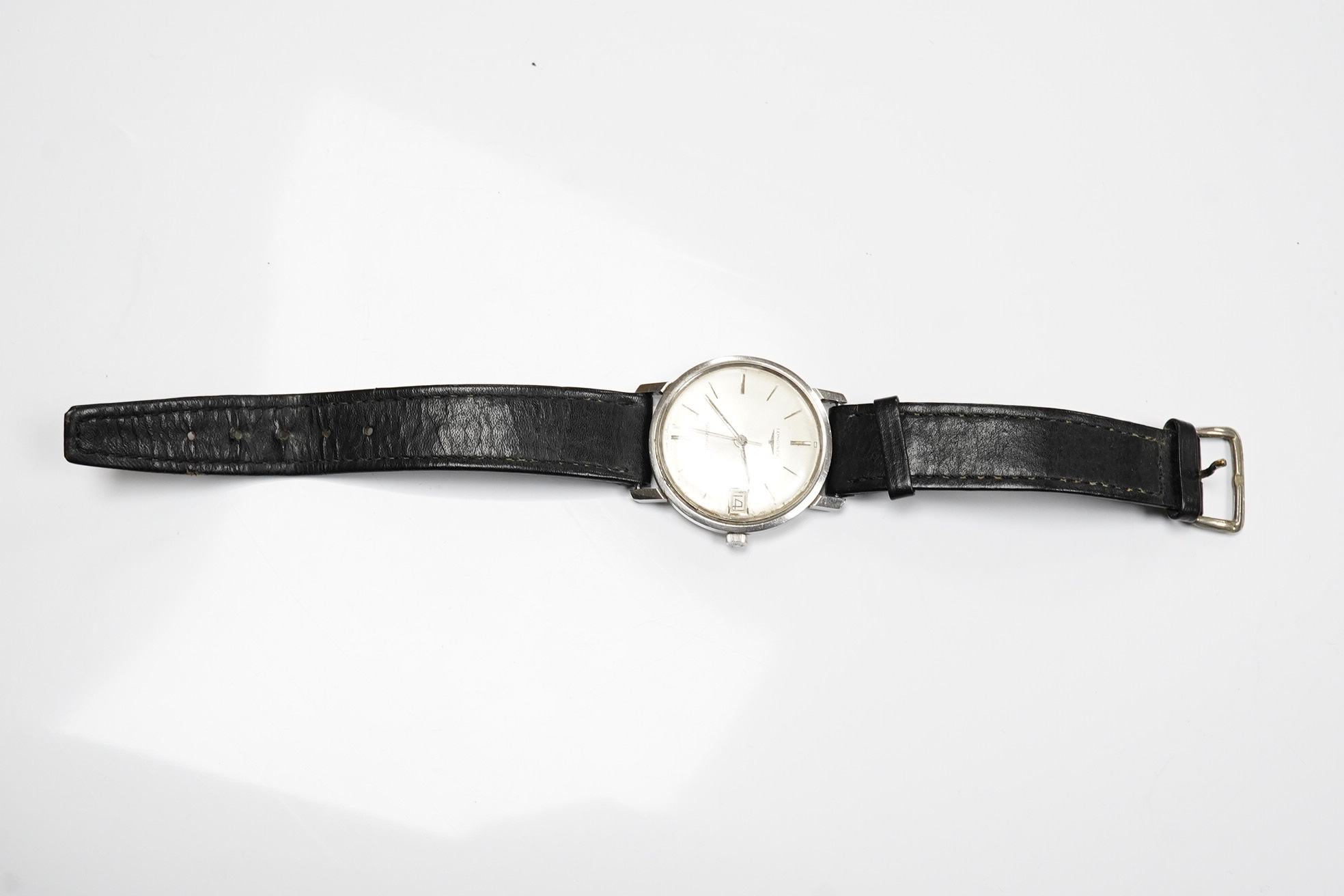 A gentleman's stainless steel Longines automatic wrist watch, with baton numerals and date aperture, case diameter 35mm, on an associated leather strap. Condition - poor